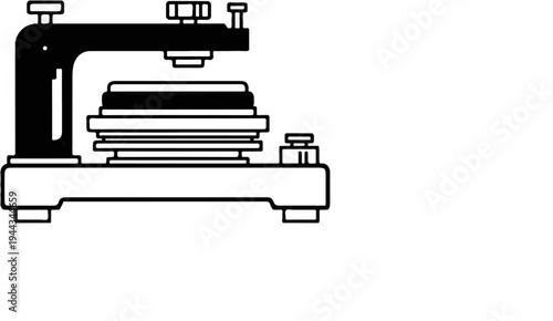 Black and white illustration of a compact industrial pressing machine
