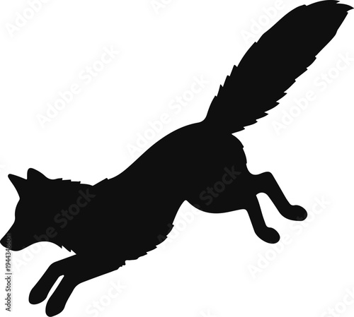 Black silhouette of a fox leaping with its bushy tail high