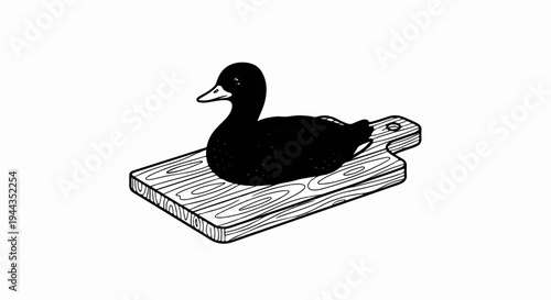 Black duck sitting on a wooden cutting board