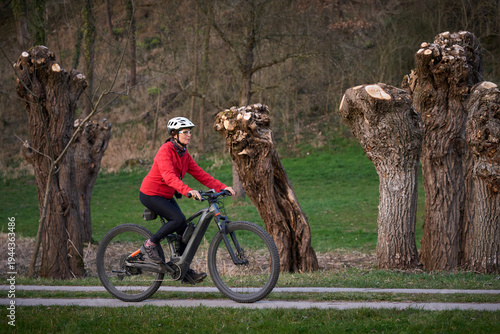Active senior woman cycling...