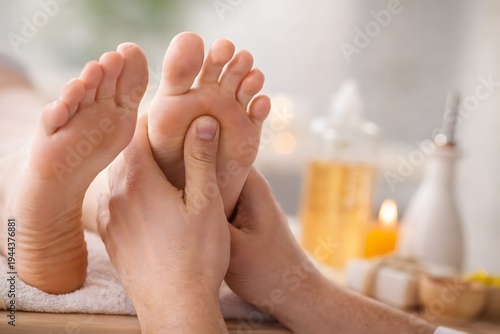 Closeup of a person receiving a relaxing foot massage at a spa with blurred background