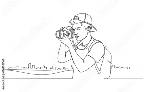 Male photographer with camera taking pictures outdoors.