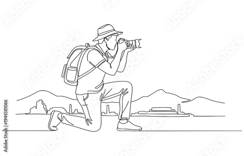 Male photographer with camera taking pictures outdoors.
