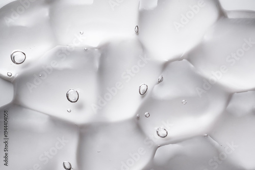 Transparent cosmetic gel with air bubbles creating an abstract pattern