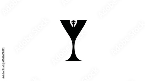 A black abstract martini glass with a floral element inside the rim