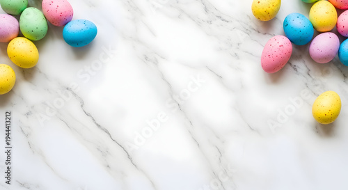 Colorful easter eggs scattered on a white marble surface