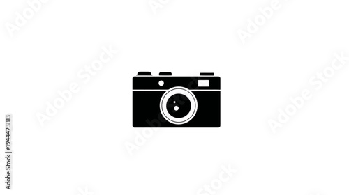 A simple, black-and-white illustration of a compact camera with its lens prominently displayed
