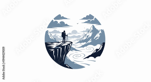 Hiker on cliff overlooking misty valley and snow-capped mountains