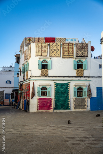 Colorful carpets hanging from a building in the medina, in Asilah, Morocco