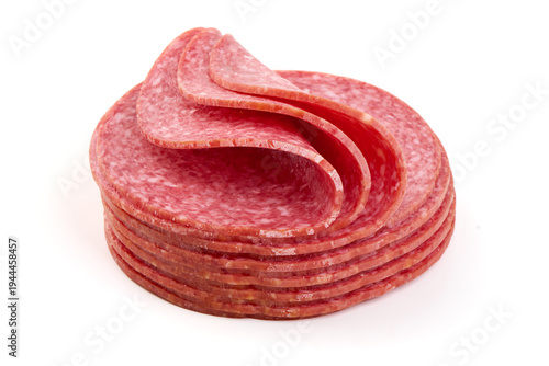 Foto Sliced salami stack, isolated on white background