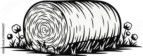 Rolled hay bale in a field with cotton plants