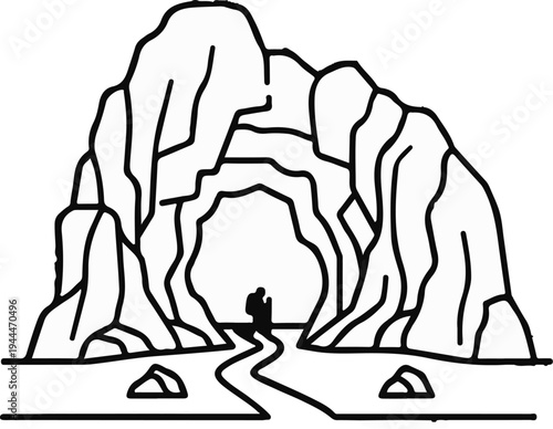 Person with backpack walking along winding path towards cave entrance in rocky mountains