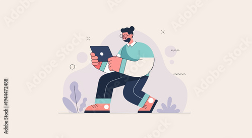 A man with a beard and glasses holds a laptop, walking