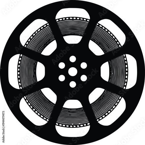 Vintage film reel with perforated edges and central hub for projection