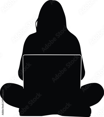 Person sitting cross-legged using a laptop with a hooded sweatshirt covering their head