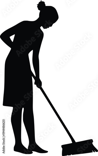 A person diligently sweeping the floor with a broom