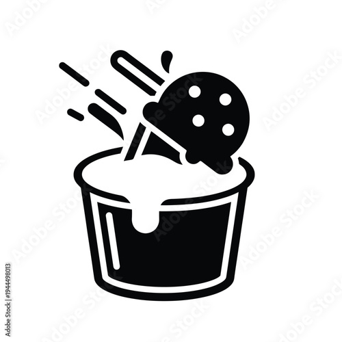 Black and white icon of an ice cream scoop falling into a cup with splashes.