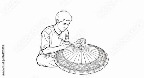 Artist painting intricate details on a large umbrella with a brush