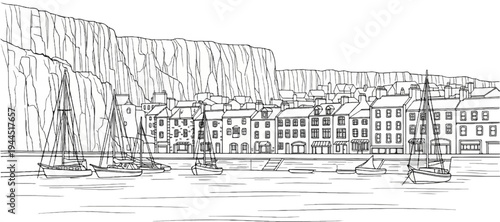 Seaside town with boats docked against a cliff and row of buildings