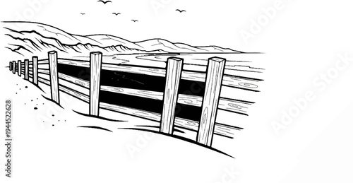 Wooden fence bordering a winding watercourse leading to distant hills