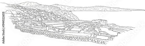 Ancient settlement on a hillside overlooking the sea with distant mountains