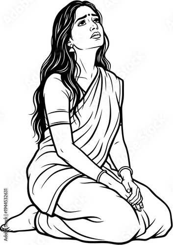 A woman in a sari kneels and looks upwards