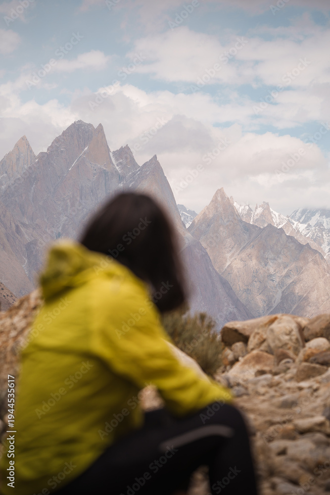 Fototapeta premium Person observing rugged mountains on baltoro trek. Baltoro