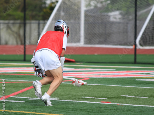Lacrosse Player Runs With Lacrosse Stick on Sports Field During Practice