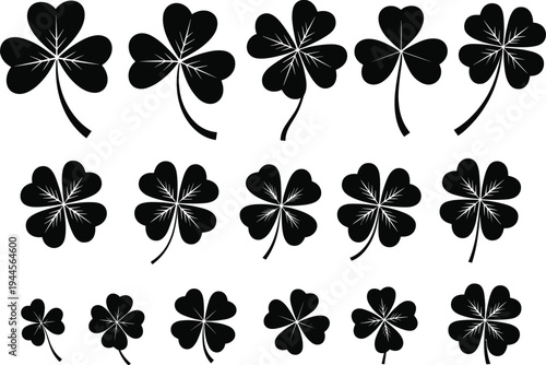 Collection of black and white four and three leaf clovers with stems in various sizes and orientations