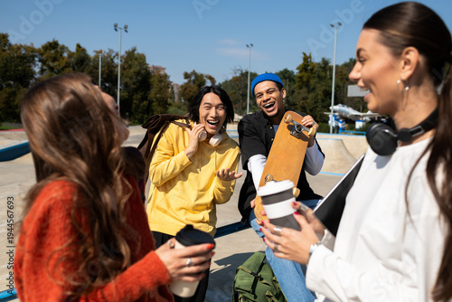 Obraz na plátne Young friends enjoying a sunny day at the skate park while sharing laughter and