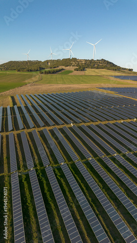Solar panels covering large countryside solar farm with panels on hill – renewable energy landscape