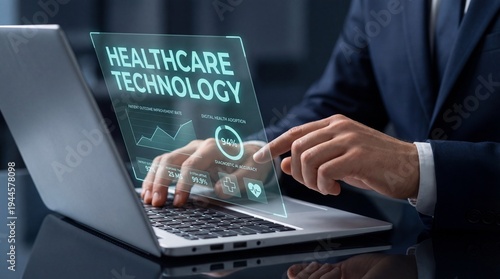 A person is working on a laptop in a corporate office. The screen shows healthcare technology with data and metrics related to patient care and diagnostics