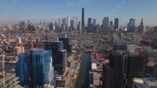 view of downtown Brooklyn skyline flying back high over Gowanus Canal 