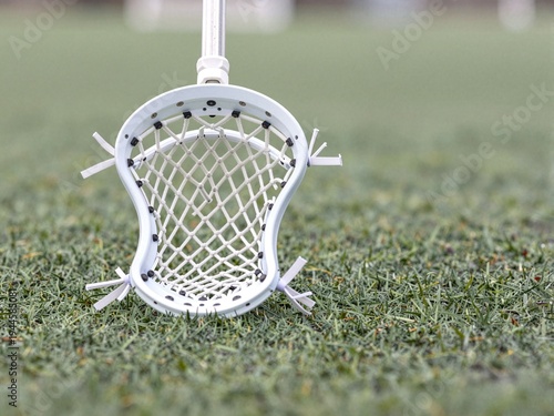 Close-up Realistic Sports Photo of Lacrosse Stick Head on Turf