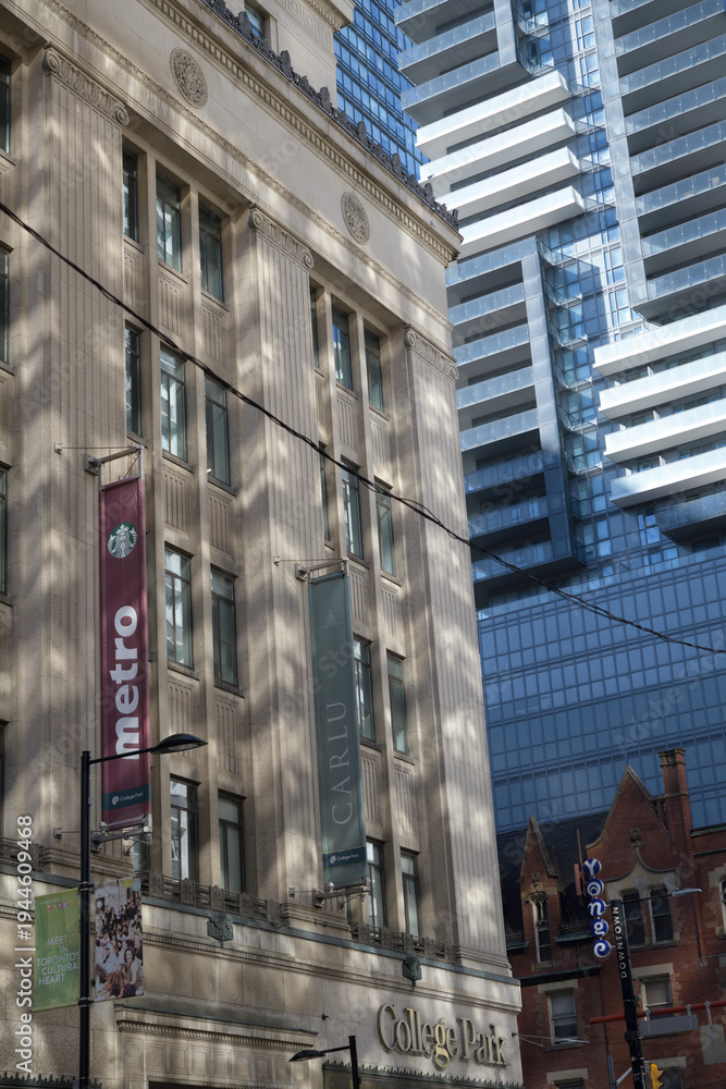 Fototapeta premium wall mounted banners for Metro, a supermarket chain, and Carlu, an event venue, at College Park, 444 Yonge St, Toronto (southwest corner at College St)