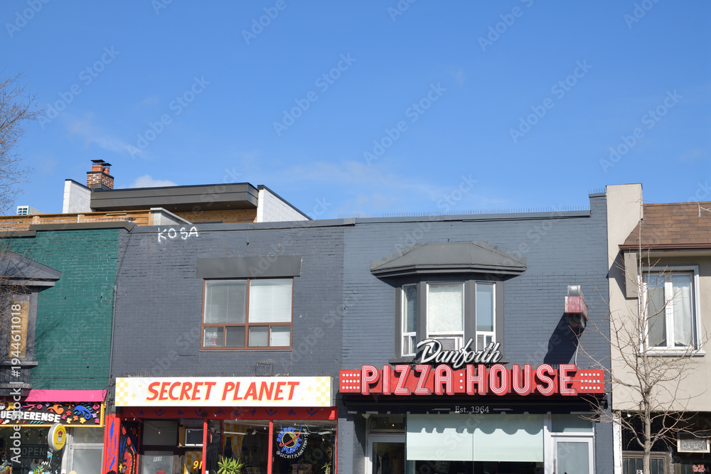 Obraz premium exterior building facade and signs of Secret Planet (918 Danforth) and Danforth Pizza House (920 Danforth), Toronto