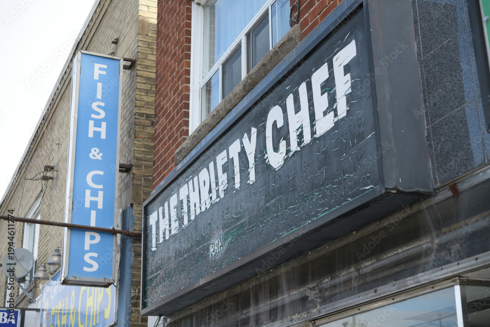 Fototapeta premium old sign above entrance to The Thrifty Chef Shop, a home goods store, located at 369 Donlands avenue, East York, Toronto