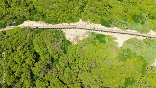 Drone aerial view above coastal shrubs and sandy path near beach Mallorca Spain