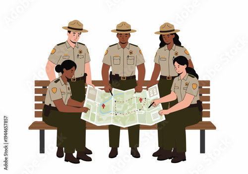 Diverse Team of Park Rangers Reviewing Map and Planning Route for Conservation and Patrol Work