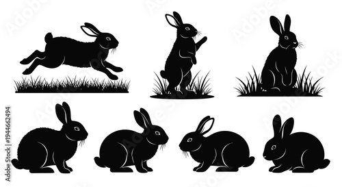 Multiple black rabbit figures stand upon detailed grass.