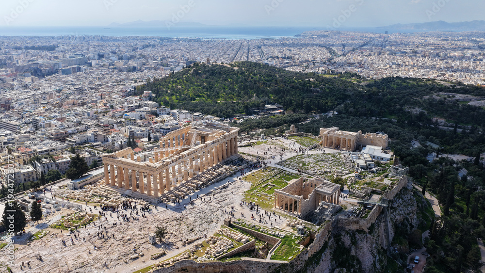 Fototapeta premium Aerial drone photo above Acropolis hill and the Parthenon featuring Propylaea and porch of the Caryatids, Athens historic centre, Attica, Greece