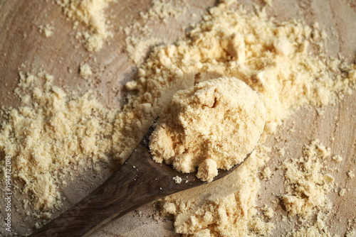 Whey protein powder on a wooden spoon
