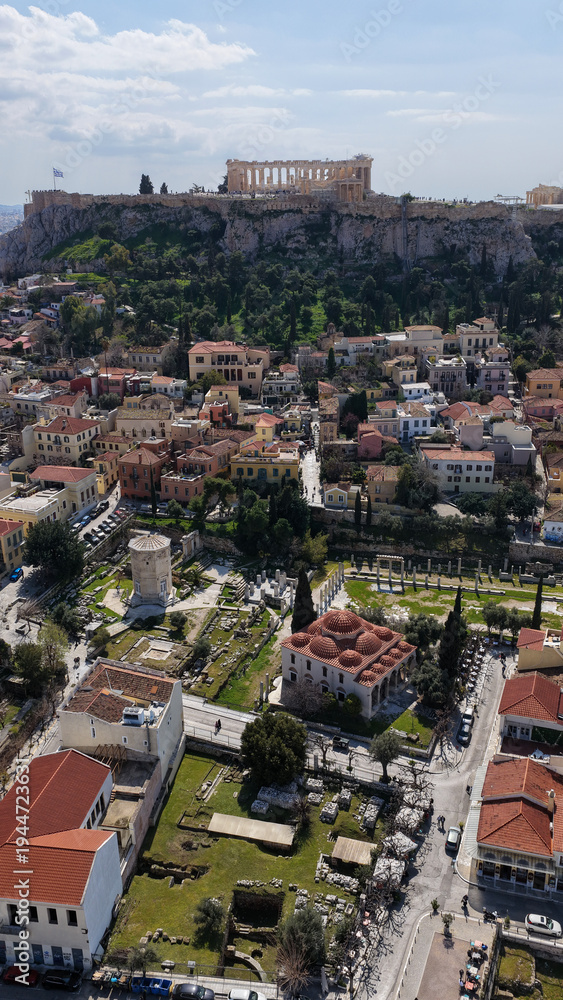 Obraz premium Aerial drone portrait photo of ancient Roman Market featuring tower of Winds and Gate of Athena in the heart of Athens historic centre built in Plaka district, below Acropolis hill, Attica, Greece