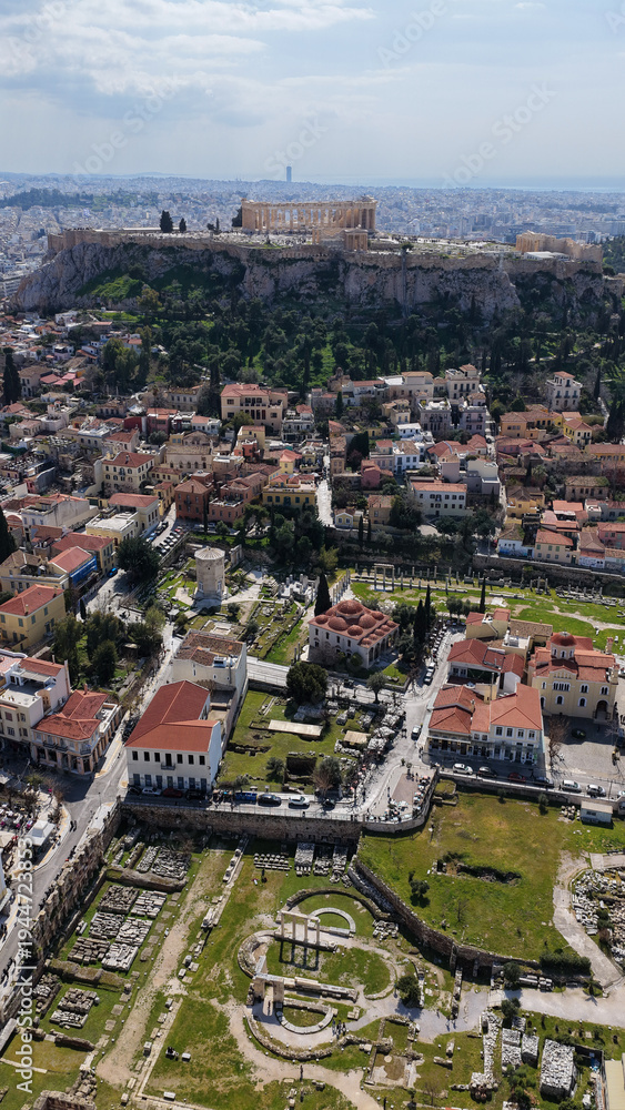 Obraz premium Aerial drone portrait photo of ancient Roman Market featuring tower of Winds and Gate of Athena in the heart of Athens historic centre built in Plaka district, below Acropolis hill, Attica, Greece