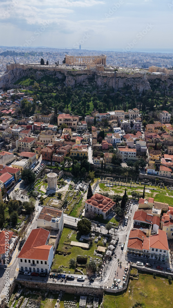 Obraz premium Aerial drone portrait photo of ancient Roman Market featuring tower of Winds and Gate of Athena in the heart of Athens historic centre built in Plaka district, below Acropolis hill, Attica, Greece