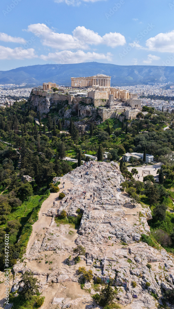 Naklejka premium Aerial drone portrait photo of iconic Areopagus hill with great views to Acropolis and The Parthenon, Athens historic centre, Atttica, Greece