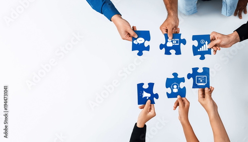 Diverse hands come together to join puzzle pieces depicting essential marketing concepts, highlighting teamwork in strategizing for business success and innovation. Amity