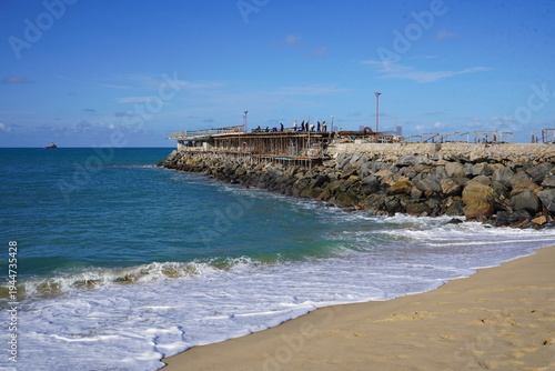 Construction work on a new pier on Iracema beach, with numerous vendor stalls and other amenities for beachgoers. Fortaleza - Ceará, Brazil.