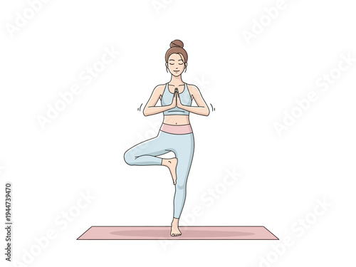 Woman practicing yoga tree pose on mat.