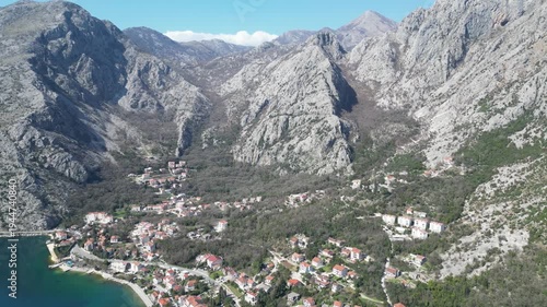 A city at the foot of a mountain on the seashore against the background of a blue spring sky